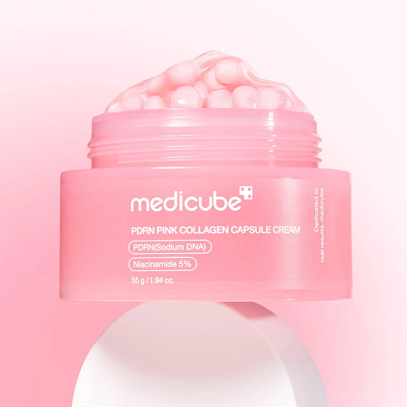 Embalagem do Medicube PDRN Pink Collagen Capsule Cream aberta sobre fundo rosa
