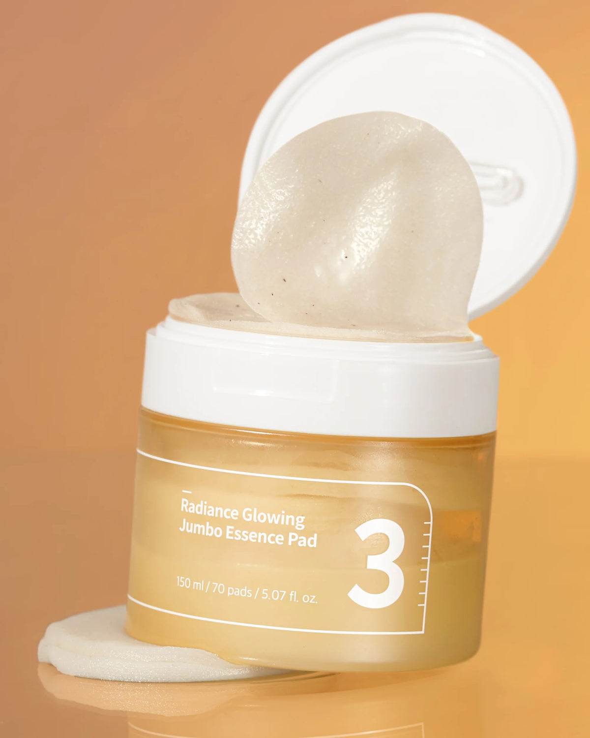 Frasco aberto do numbuzin No.3 Essence Pad com disco de tónico-essência e tampa erguida
