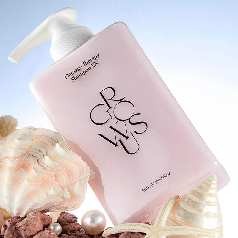 Embalagem do Growus Damage Therapy Shampoo EX rodeada de conchas e pérolas