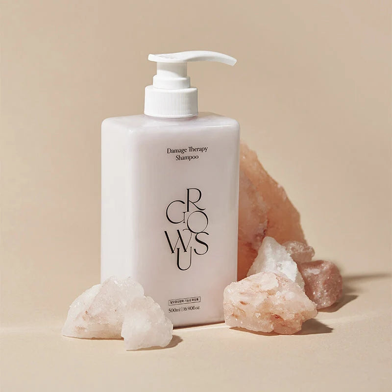 Garrafa do Growus Damage Therapy Shampoo junto a pedras de sal rosa do Himalaia