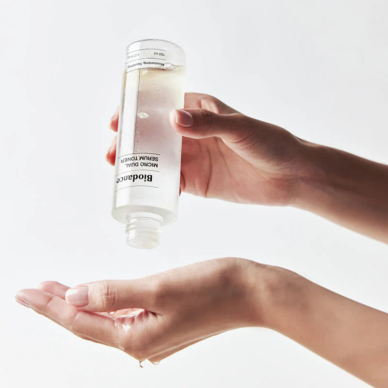 Aplicação do tónico Biodance nas mãos, a partir do frasco invertido