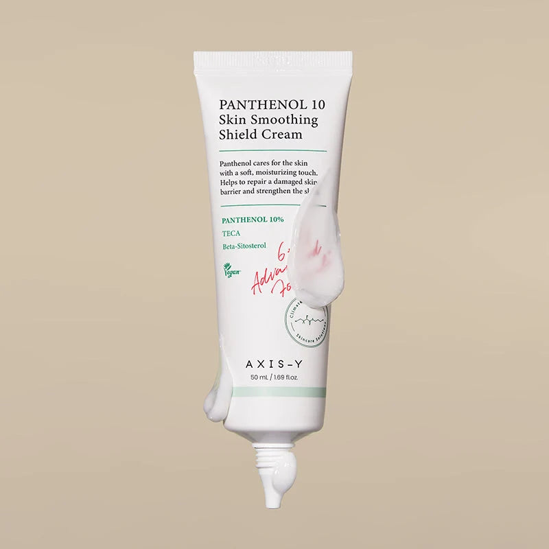 Bisnaga virada para baixo a dispensar o creme sobre fundo bege